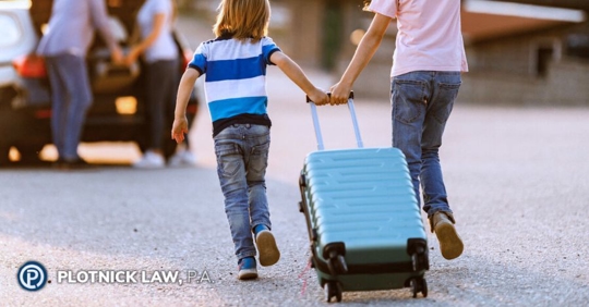 children dragging a suitcase