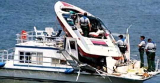 a boat wrecked on top of another boat.