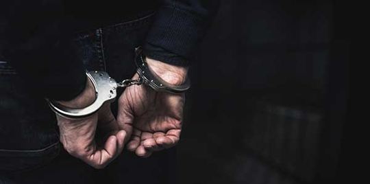 a person in handcuffs.
